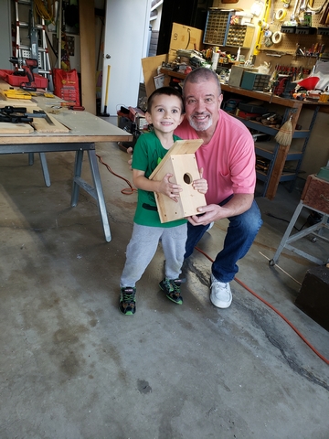 Peter making a birdhouse with his grandson AJ